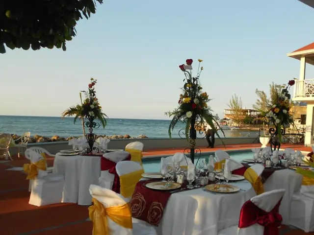 Tables set on the terrace at Pipers Cove Resort, facing the sea